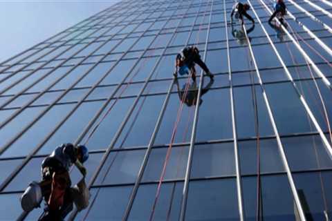 How do professionals clean high windows?